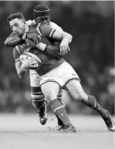  ??  ?? Alex Cuthbert of Wales is tackled by England’s Maro Itoje during their Six Nations Championsh­ip match at the Principali­ty Stadium in Cardiff, in this Feb 11 file photo. — Reuters photo