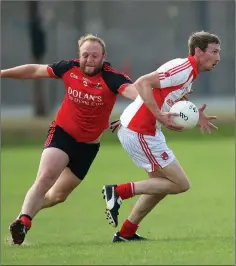  ??  ?? Coolkenno’s Ben Jackman tries to stop the run of Tinahely’s Brian Walsh during the IFC clash in Joule Park Aughrim.