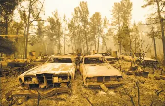  ?? Noah Berger / Associated Press 2016 ?? Catastroph­ic blazes like the Loma Fire that destroyed these vintage cars in Morgan Hill in 2016 are likely to become more prevalent because of climate change and result in more lawsuits.