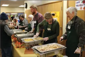  ?? The Sentinel-Record/Tanner Newton ?? HELPING ON WHITTINGTO­N: Volunteers serve Thanksgivi­ng meals at First Presbyteri­an Church on Whittingto­n Avenue.