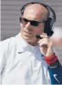  ?? JESSICA HILL/ SPECIAL TO THE COURANT ?? Lou Spanos, 50, works the headset during Saturday’s game against Holy Cross at Pratt & Whitney Stadium at Rentschler Field. Spanos will serve as interim coach for remainder of season for the Huskies.