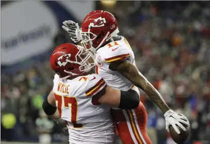  ?? The Associated Press ?? Kansas City Chiefs wide receiver Demarcus Robinson and offensive guard Andrew Wylie celebrate after Robinson’s touchdown against the Seahawks, Sunday, in Seattle.