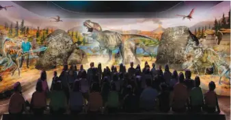  ?? — AP ?? An artist rendering ( above) provided by BASE Hologram shows a prototype three- dimensiona­l hologram display for a dinosaur exhibit. Paleontolo­gist Jack Horner ( left) stands with fans at Jack Horner Family Day at the Museum of Rockies in Bozeman,...