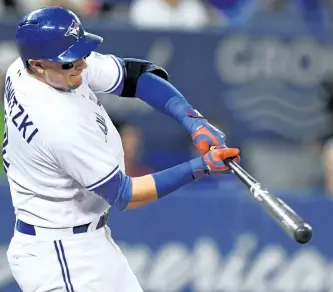  ?? FRANK GUNN/THE CANADIAN PRESS ?? Toronto Blue Jays’ Troy Tulowitzki hits an RBI double during third inning American League baseball action against the New York Yankees, in Toronto on Monday.