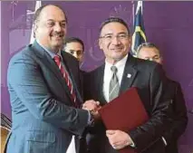  ?? PIC BY YAZIT RAZALI ?? Datuk Seri Hishammudd­in Hussein and Dr Khalid Mohamed Al-Atiyyah after signing a letter of intent in Kuala Lumpur yesterday.