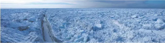  ??  ?? A break forms in the Arctic Ocean ice beyond Utqiagvik, Alaska, near the northernmo­st point in the United States.