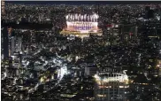  ?? KIICHIRO SATO - AP ?? Fireworks illuminate over National Stadium during the closing ceremony of the 2020Tokyo Olympics, seen from the Shibuya Sky observatio­n deck, Sunday, in Tokyo.