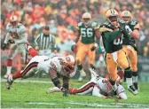  ?? DAVID BOE/AP ?? Packers wide receiver/kick returner Desmond Howard eludes 49ers linebacker Kevin Mitchell, left, and punter Tommy Thompson on the way to a touchdown on a punt return in 1997.