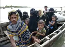  ?? SUVRA KANTI DAS, THE ASSOCIATED PRESS ?? Members of Myanmar’s Muslim Rohingya minority sit in a boat to cross a canal at Shah Porir Deep, in Teknak, Bangladesh. Several boats have capsized since Aug. 25, killing dozens of people.