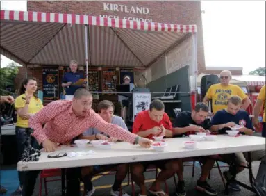  ?? JONATHAN TRESSLER — THE NEWS-HERALD ?? The new Kirtland Kiwanis Strawberry Festival shortcake-eating contest champ Ivan “The Avocado” Mendoza, who hails from Sheffield, reaches for his sixth and final shortcake during the contest on festival’s opening day June 15.