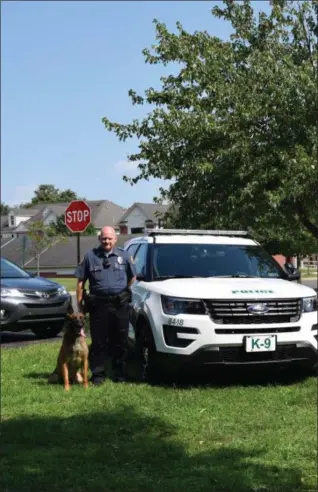  ?? MARIAN DENNIS — DIGITAL FIRST MEDIA ?? Officer Chris Wienczek with K-9 partner “Rambo” (left), Speck Landis (center) and Officer Kevin McGuigan with K-9 partner “Flynn” stand together outside the Limerick Township Police Department.