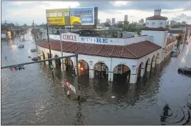  ?? THE ASSOCIATED PRESS ?? The Circle Food Store in New Orleaans is engulfed in floodwater­s on Saturday, even as more rain was forecast and city water pumps were malfunctio­ning after weekend floods,