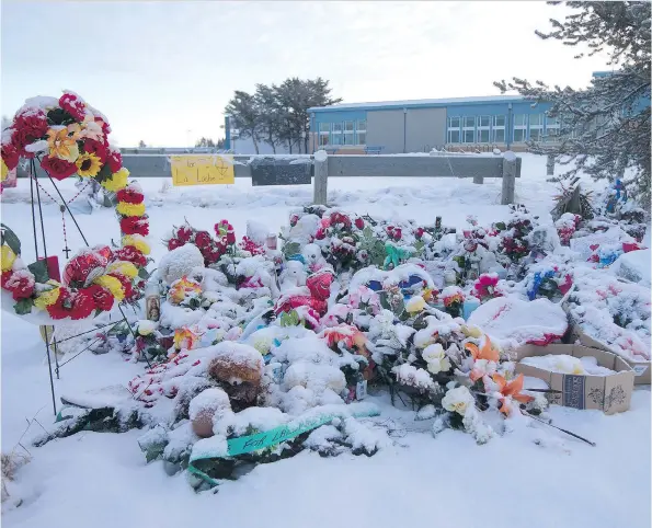  ?? LIAM RICHARDS ?? The sun rises over a memorial La Loche Community School on Wednesday, Feb. 3. On Jan. 22 four people were killed and seven others were injured in a shooting spree at the Dene Building. The alleged shooter is a 17-year-old boy.