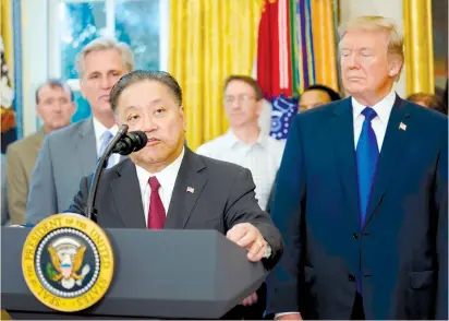  ?? (Carlos Barria/Reuters) ?? BROADCOM CEO Hock E. Tan addresses the media with US President Donald Trump at his side last Thursday at the White House. The bid for Qualcomm is an ambitious move by Tan, who turned a small, scrappy chipmaker into a $100b. company based in Singapore...