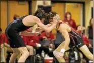  ?? NATE HECKENBERG­ER - FOR DIGITAL FIRST MEDIA ?? Boyertown’s Julien Maldonado takes a hand to the eye but pushed through for a major decision against Great Valley’s Ken Levin at 106 pounds.