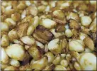  ?? STAFF FILE PHOTO ?? Roasted garlic cloves move along a production line at Christophe­r Ranch in Gilroy. Recent demand has skyrockete­d.