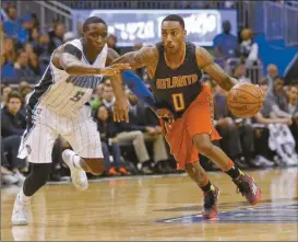  ?? John Raoux/AP ?? Atlanta Hawks’ Jeff Teague (0) drives around Orlando Magic’s Victor Oladipo (5) during the second half of an NBA basketball game, Sunday, Feb. 7, 2016, in Orlando, Fla. Orlando won 96-94.