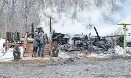  ?? MCCARTHY/JOURNAL PIONEER ?? Cathy and Don Bryer examine the fire scene from their front step, all that remains of their Dunblane farmhouse. Their two-story home was already fully engulfed when firefighte­rs arrived early Friday afternoon.ERIC