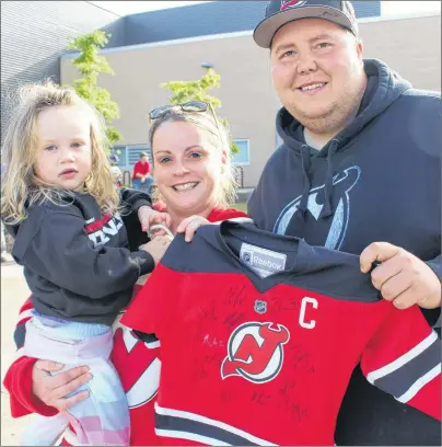  ?? MILLICENT MCKAY/JOURNAL PIONEER ?? Ryan and Kelly Mann of Kensington brought their three-year-old daughter to the Credit Union Place early Monday morning to get her jersey signed by The New Jersey Devils.