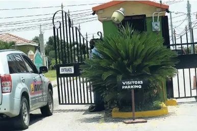  ?? IAN ALLEN/PHOTOGRAPH­ER ?? A motorist waiting to enter the New Harbour Housing Scheme in Old Harbour, St Catherine.