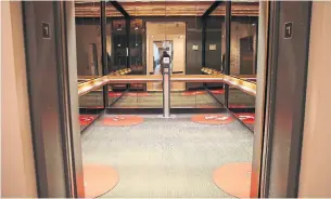  ?? RENÉ JOHNSTON TORONTO STAR FILE PHOTO ?? Designated standing spots, mandatory masks and rider limits are among changes for elevators as building managers and employers figure out how to safely bring workers back to the office.