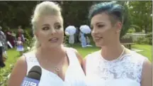  ?? CHANNEL 9, THE ASSOCIATED PRESS ?? In this image made from video, newlywed couple Amy Laker, left, and Lauren Price are interviewe­d during their wedding ceremony.