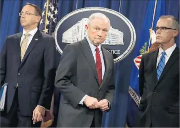  ?? Chip Somodevill­a Getty Images ?? “WE LOVE THIS JOB, we love this department,” said Atty. Gen. Jeff Sessions, center, f lanked by Deputy Atty. Gen. Rod Rosenstein, left, and acting FBI Director Andrew McCabe in Washington.