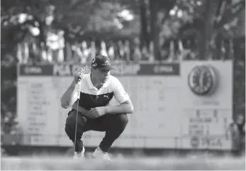  ?? AP PHOTO ?? Gary Woodland surveys a putt on the 18th green during the first round of the PGA Championsh­ip on Thursday in St. Louis.