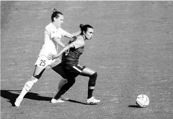  ?? WILLIE J. ALLEN JR./ORLANDO SENTINEL ?? Orlando Pride’s Marta fights for the ball with Meredith Speck (25) during the first half of an NWSL soccer match at Exploria Stadium on Oct., 17, 2020.