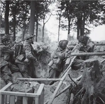  ??  ?? British soldiers taking cover in a shell hole near Arnhem, the Netherland­s, September 17, 1944