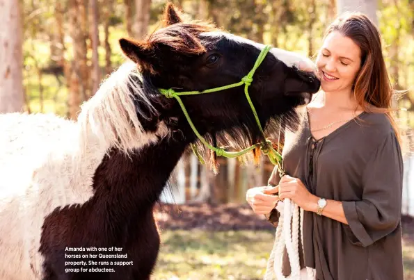  ??  ?? Amanda with one of her horses on her Queensland property. She runs a support group for abductees.