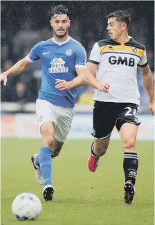  ??  ?? Andrew Hughes takes on Port Vale’s Alex Jones.