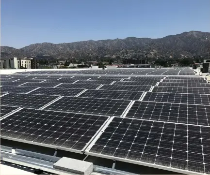  ?? (Nichola Groom/Reuters) ?? SOLAR PANELS are seen on the roof of a new IKEA store in Burbank, California, last week. Costs for solar and wind are plunging thanks to technologi­cal advances and increased global production of panels and turbines.