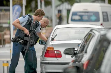  ?? DAVID WALKER/STUFF ?? Armed police search vehicles parked outside Christchur­ch Hospital after the multiple shootings.