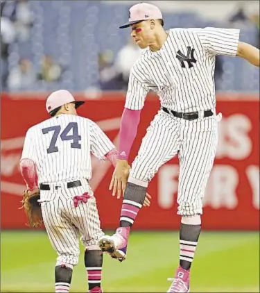  ?? AP ?? Giancarlo Stanton has four hits, including a home run, Sunday afternoon in what may prove to be his breakout game as Aaron Judge and Ronald Torreyes celebrate a Yankee win on Mother’s Day.