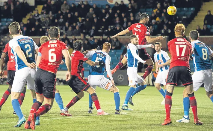  ?? Pictures: SNS Group. ?? Former England internatio­nalist Steven Caulker rises above the Killie defence to grab a debut goal for the Dark Blues.