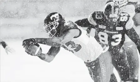  ?? CANADIAN PRESS FILE PHOTO ?? Calgary Stampeders running back Jerome Messam dives into the end zone for a touchdown ahead of Toronto Argonauts defensive tackle Linden Gaydosh (93) during first-half Canadian Football League action in the 105th Grey Cup game on Nov. 26, 2017, in...