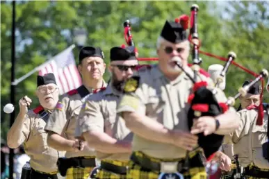  ?? STAFF PHOTOS BY C.B. SCHMELTER ?? Mike Roberts, left, and the Alhambra Highlander Pipe and Drums band lead the Lakeview-Fort Oglethorpe High School Army JROTC Honor Guard during the Honoring Those Who Serve event at Honor Park on Saturday in Fort Oglethorpe, Ga.