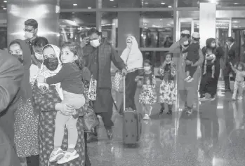  ?? KARIM JAAFAR/GETTY-AFP ?? Evacuees from Afghanista­n arrive Friday at Hamad Internatio­nal Airport in Qatar’s capital Doha.