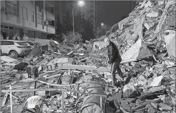  ?? DEPO PHOTOS VIA AP ?? A man makes his way through collapsed buildings in Diyarbakir, Turkey, early Monday. A powerful 7.8 magnitude earthquake killed more than 3,400 in Turkey and Syria.