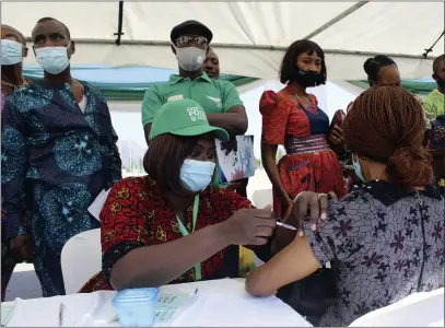  ?? GBEMIGA OLAMIKAN — THE ASSOCIATED PRESS FILE ?? A woman receives an AstraZenec­a coronaviru­s vaccine in Abuja, Nigeria, on Nov. 19. The emergence of the new omicron variant and the world’s desperate and likely futile attempts to keep it at bay are reminders of what scientists have warned for months: The coronaviru­s will thrive as long as vast parts of the world lack vaccines.