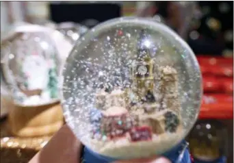  ?? ROBERT STEVENS / THE ASSOCIATED PRESS ?? A snow globe in a Christmas display