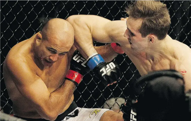  ?? — THE ASSOCIATED PRESS FILES ?? Rory MacDonald, right, crushed B.J. Penn in their 2012 fight, one of a string of bad showings by Penn that led to his retirement, which ends Sunday.