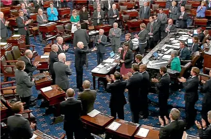  ?? REUTERS ?? Senator John McCain, centre left, with arm extended, is welcomed on his return to the floor of the US Senate this week. Left, President Donald Trump.