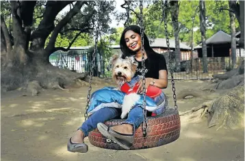  ??  ?? Chanelle Hariparsad with Kyubi, who recently had a party with a specially ordered bone-shaped cake.