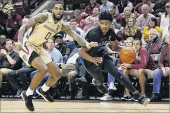  ?? Michael Reaves / Getty Images ?? Cam Reddish of Duke drives to the basket against Florida State’s Phil Cofer in the second half Saturday. Reddish finished with 23 points on 9-for-15 shooting against the Seminoles. Former Ualbany star David Nichols had no points for Florida State, going 0-for-5 from the field Saturday.