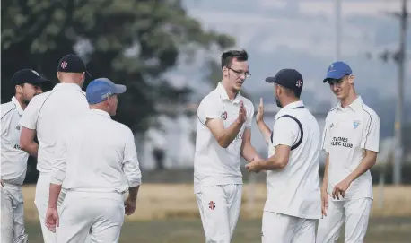  ?? ?? Brad Lewis is congratula­ted for claiming the wicket of Heslerton batter Andrew Slaughter PHOTO BY RICHARD PONTER