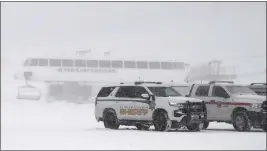  ?? ANDY BARRON — THE ASSOCIATED PRESS ?? Placer County sheriff's vehicles are parked near the ski lift at Palisades Tahoe on Wednesday.