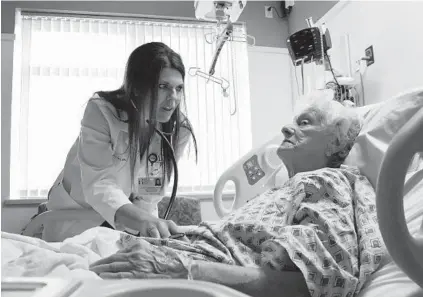  ?? AMY DAVIS/BALTIMORE SUN ?? Kelly Corcoran, a physician assistant hospitalis­t at the Anne Arundel Medical Center, monitors patient Mary Franklin of Bowie. Physician assistants are increasing­ly serving as the point person for patient care.