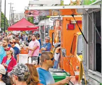 ?? STAFF FILE PHOTO BY ROBIN RUDD ?? First Tennessee Pavilion’s plaza was packed with people and food trucks at the 2017 Street Food Festival held at Chattanoog­a Market. Two dozen trucks will roll down Carter Street for the festival on Saturday and Sunday.